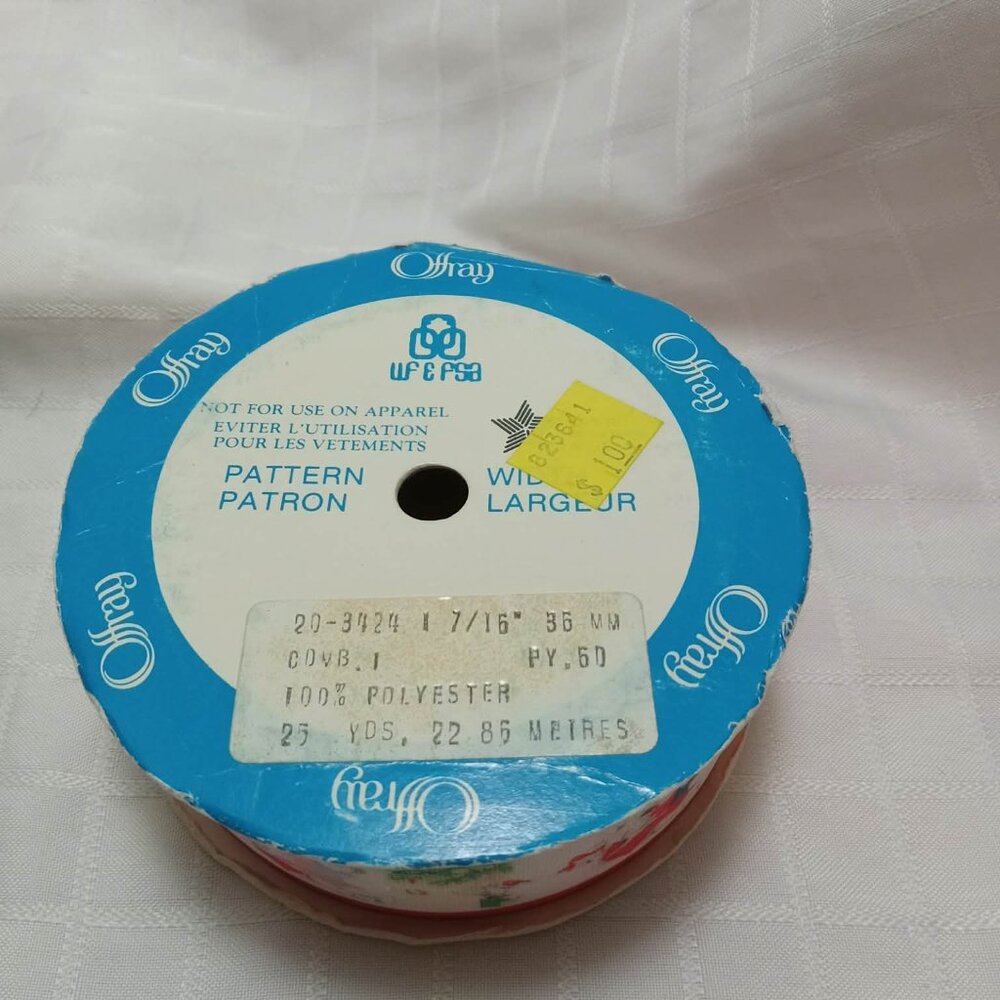 The remaining long length of a roll of vintage ribbon with an Christmas pattern